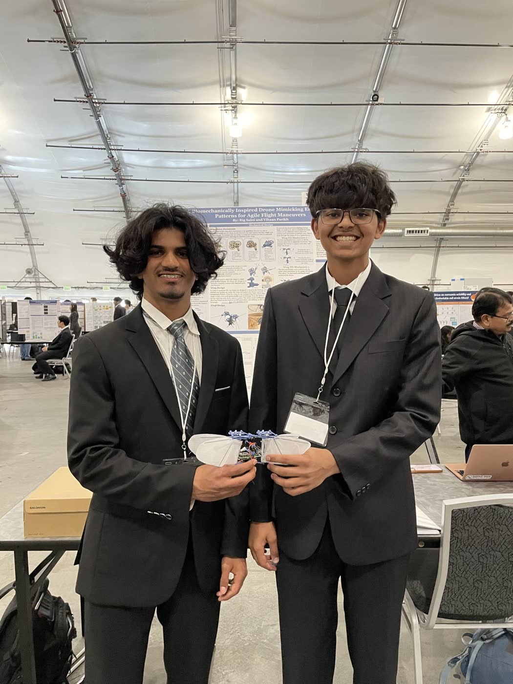 Vihaan and Rig Saini holding BioFlap at the science fair